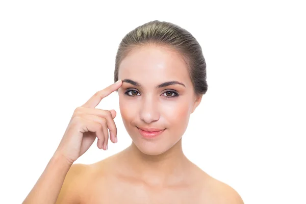 Smiling woman touching her eyebrow — Stock Photo, Image