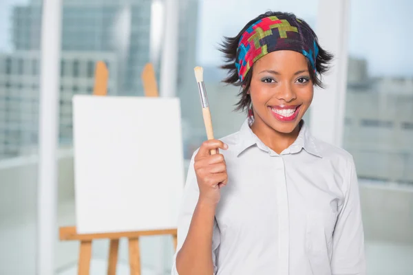 Smiling artist showing her brush — Stock Photo, Image