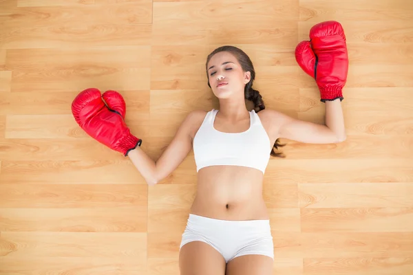 Sporty tired wearing red boxing gloves — Stock Photo, Image