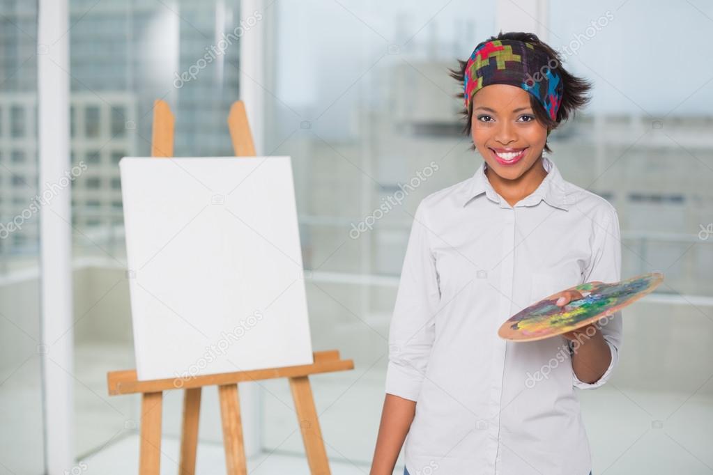 Smiling artist holding palette