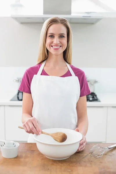Casual cheerful blonde holding wooden spoon — Stock Photo, Image