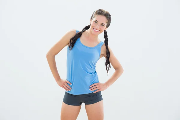 Smiling woman in sportswear and plaits — Stock Photo, Image