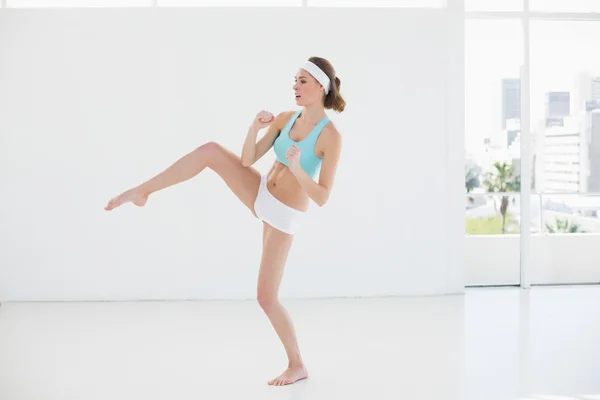 Sporty slim woman doing sports in sports hall — Stock Photo, Image