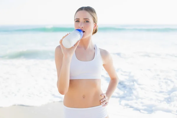 Content slender woman drinking from sports bottle — Stock Photo, Image