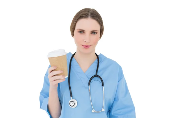 Young female doctor holding a coffee mug — Stock Photo, Image