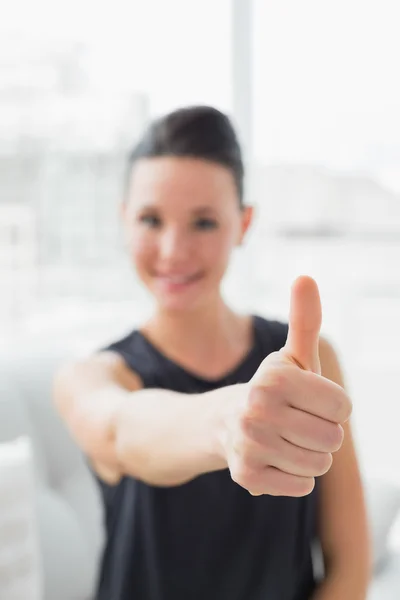 Blurred smiling well dressed woman gesturing thumbs up — Stock Photo, Image