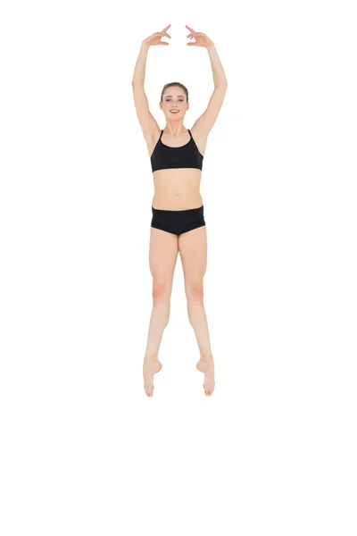 Happy slim ballet dancer jumping in the air — Stock Photo, Image