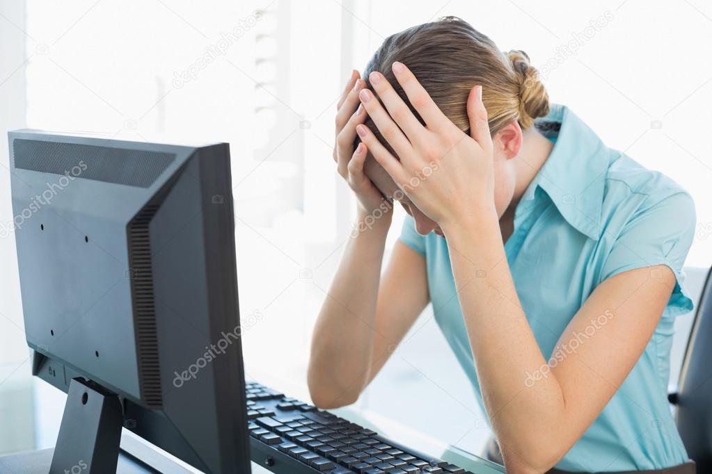 Classy frustrated businesswoman working at computer