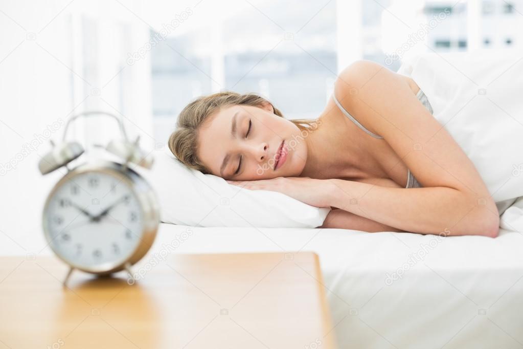 Attractive woman lying in her bed sleeping