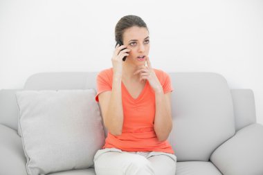 güzel düşünce kadın ile kanepede oturan smartphone telefon ederek