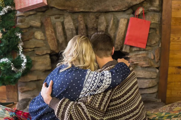 Romantic couple embracing in front of fireplace — Stock Photo, Image