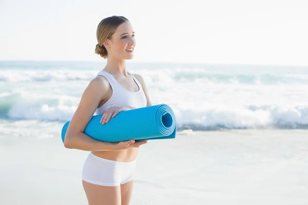 Lovely young woman holding an exercise mat — Stock Photo, Image