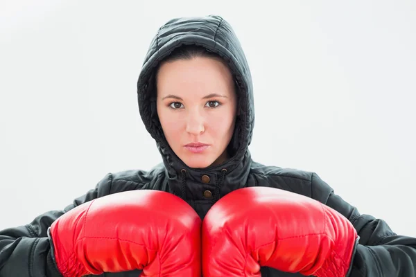 Schöne junge Frau mit Kapuze und roten Boxhandschuhen — Stockfoto