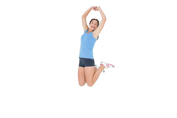 Sporty woman jumping over white background — Stock Photo, Image