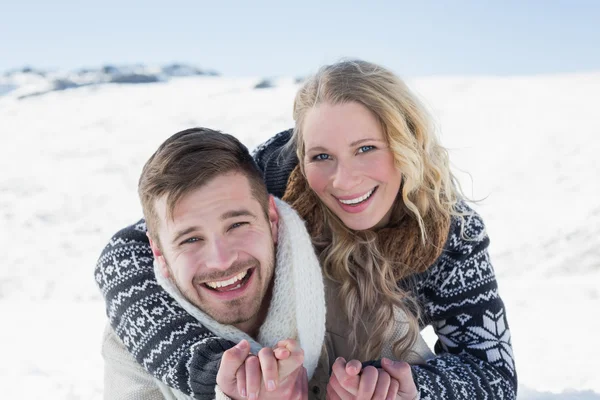 Close-up of a cheerful couple holding hands on snow — Stock Photo, Image