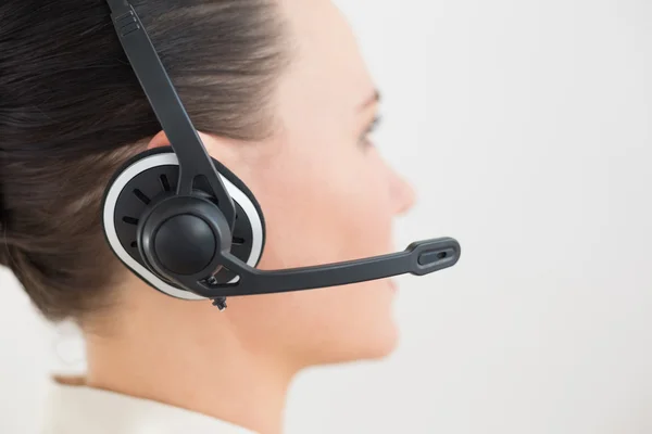 Close-up side view of a beautiful businesswoman using headset — Stock Photo, Image