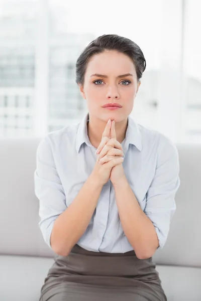 Serious elegant young woman sitting at home — Stock Photo, Image