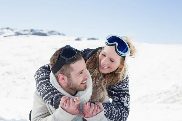 Close-up of a cheerful couple with ski goggles on snow — Stock Photo, Image