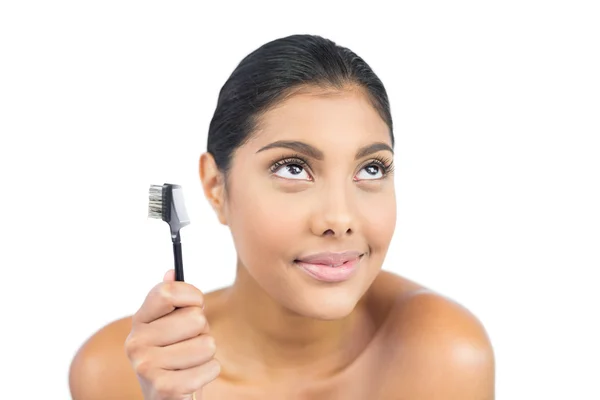 Content nude brunette holding eyebrow brush — Stock Photo, Image