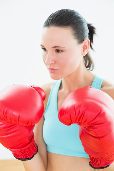 Close-up of a beautiful young woman in red boxing gloves — Stock Photo, Image