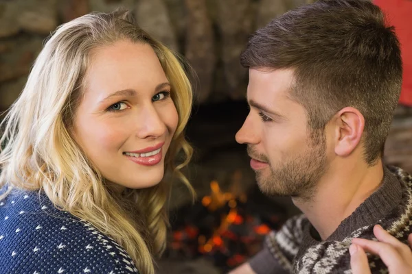 Close-up of a romantic couple in front of fireplace — Stock Photo, Image