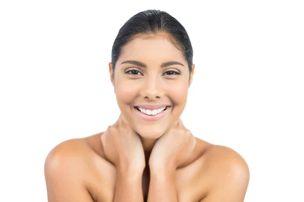 Smiling nude brunette holding her neck — Stock Photo, Image