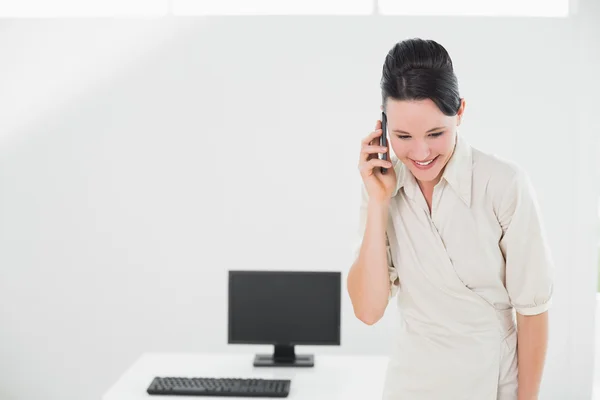 Businesswoman using cellphone in office — Stock Photo, Image