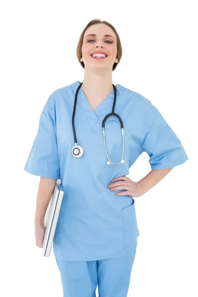 Young female doctor holding a notebook and laughing into the camera — Stock Photo, Image