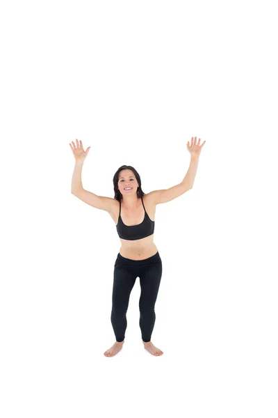 Sporty young woman about to jump over white background — Stock Photo, Image