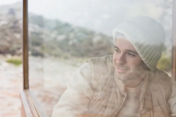 Thoughtful man looking out through window — Stock Photo, Image