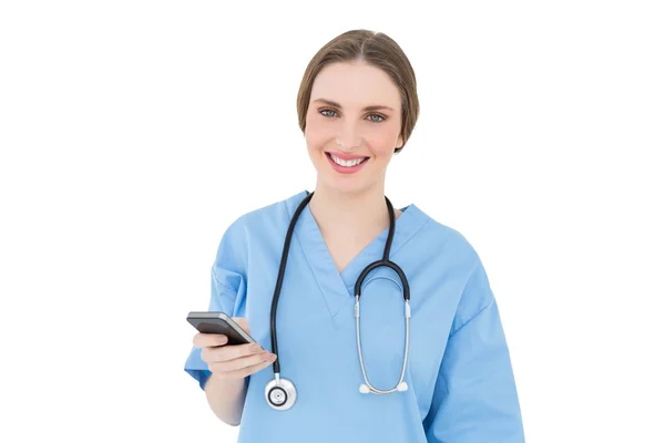 Young woman doctor holding her smartphone — Stock Photo, Image