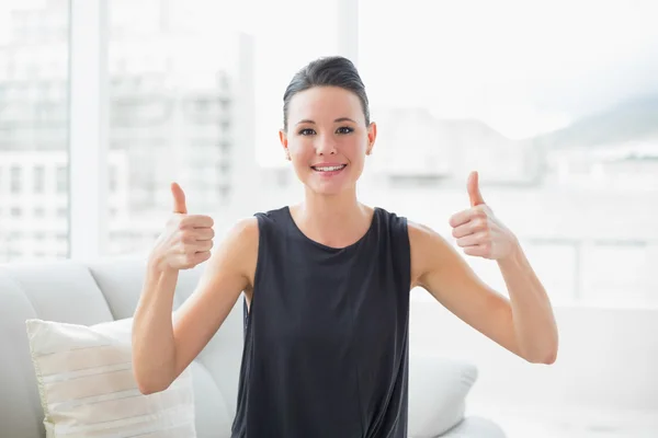 Leende välklädd kvinna gestikulerande tummen upp — Stockfoto