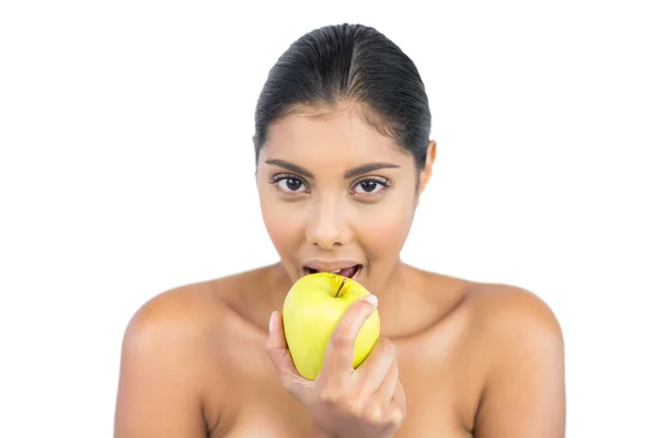 Happy nude brunette eating green apple — Stock Photo, Image