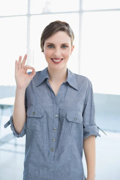 Businesswoman making positive gesture — Stock Photo, Image