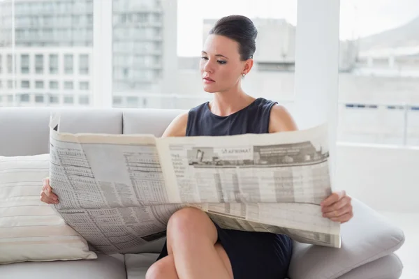 Vacker affärskvinna läsa tidningen på soffa — Stockfoto