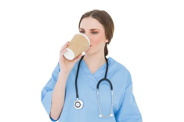 Female doctor drinking coffee — Stock Photo, Image