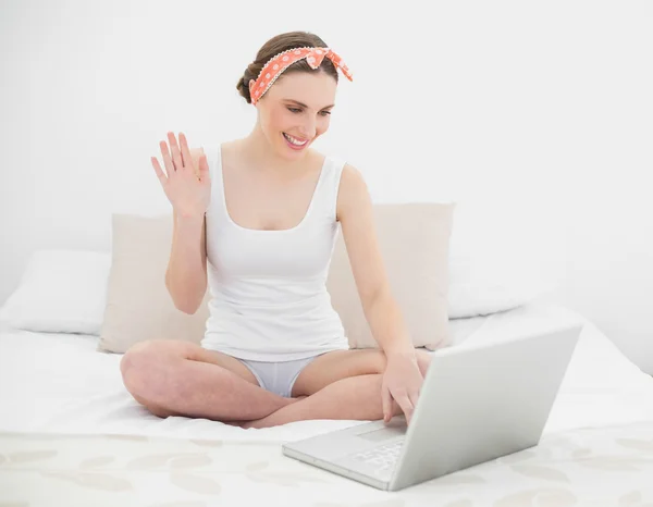 Young woman video chatting with her notebook — Stock Photo, Image