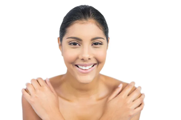 Cheerful nude brunette holding shoulders — Stock Photo, Image