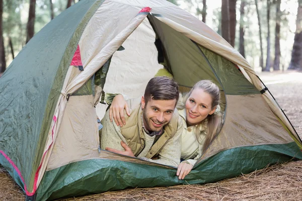 Happy couple lying in tent after a hike — Stock Photo, Image