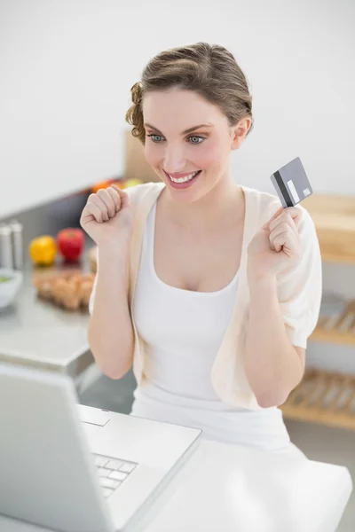 Cheerful attractive woman home-shopping with her notebook — Stock Photo, Image