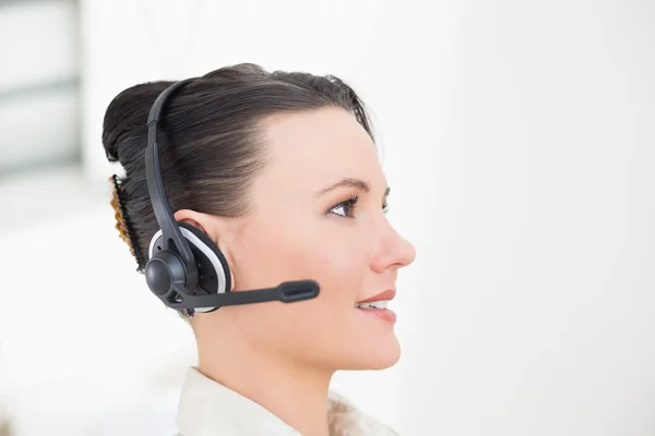Close-up side view of a beautiful businesswoman using headset — Stock Photo, Image