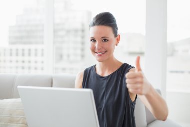 dizüstü el başparmak yukarıya ile güzel iyi giyimli bir kadın