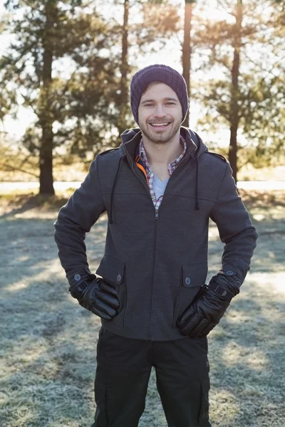 Portrait of a young man in warm clothing in forest — Stock Photo, Image