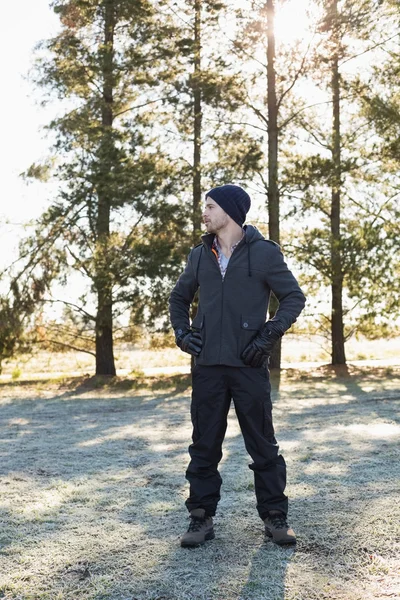 Man in warm clothing while having a walk in forest on a winter d — Stock Photo, Image