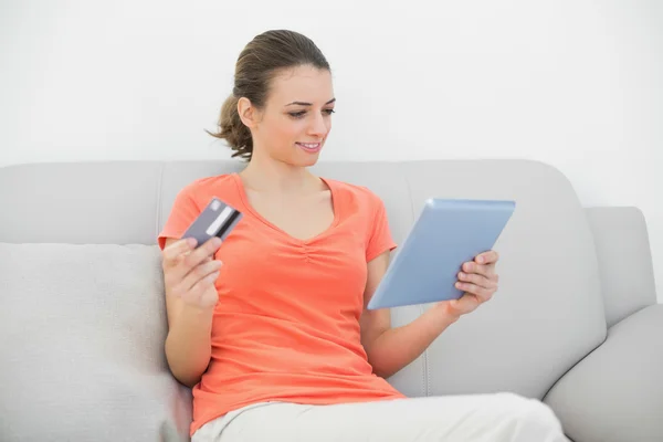 Lovely brunette woman home shopping with her tablet — Stock Photo, Image