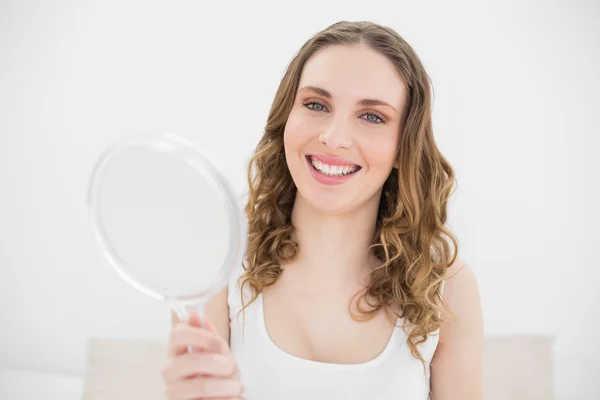 Pretty woman holding a mirror — Stock Photo, Image