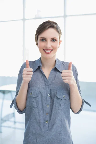 Pretty businesswoman showing thumbs up — Stock Photo, Image