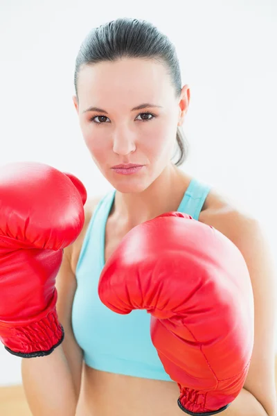 Close-up portrait of a beautiful woman in red boxing gloves — Stock Photo, Image