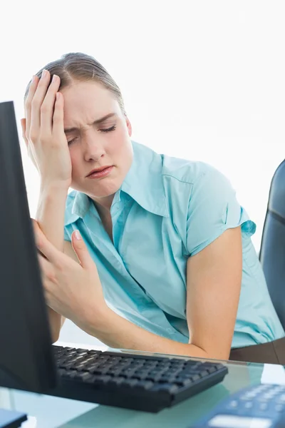 Classy wincing businesswoman having a headache — Stock Photo, Image