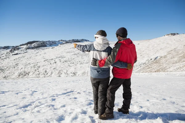 Rückansicht eines Ehepaares auf Schnee in voller Länge — Stockfoto